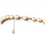 pearl necklace on a chain on a white background