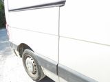 a white van that is parked on the side of the road