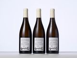 three bottles of wine sitting on top of a table next to each other