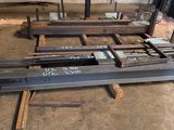 a large group of steel beams in a warehouse