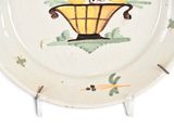 a white plate with a painting of a bird on it
