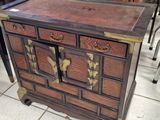 a small wooden cabinet with many drawers on it
