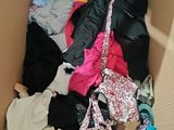 a cardboard box filled with clothes and a pair of shoes