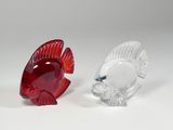 pair of red and clear glass fish figurines on a white surface