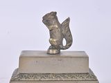a statue of a squirrel sitting on top of a box