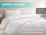 the comforter is white and has four pillows on top of it