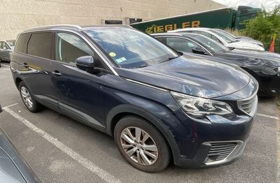 a blue car parked in a parking lot next to other cars