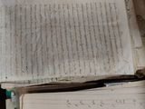 a open book sitting on top of a table next to a pen