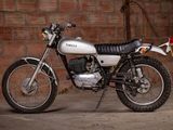 a motorcycle that is parked in front of a brick wall