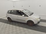 a small white car that is parked in a garage