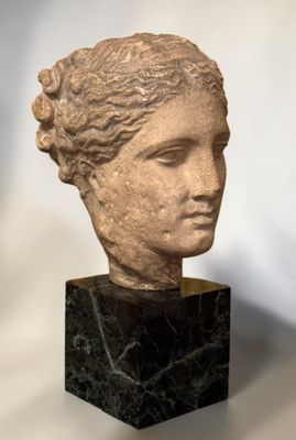 marble head of a woman on a black marble base