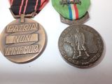 three medals are sitting on a table with ribbons around them