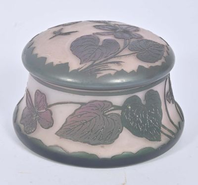 a glass box with a design of leaves on it