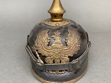 a helmet that has a gold decoration on it