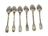 six spoons are lined up in a row on a white surface