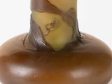 a brown vase with a yellow and brown design on it