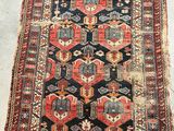 an antique persian rug with geometric design