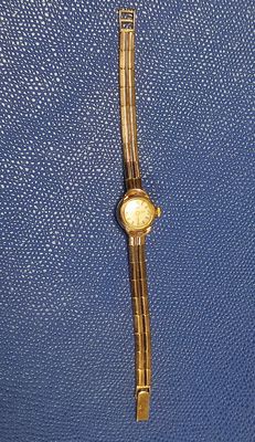 a blue purse with a gold watch on it
