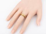 gold plated ring with a thin band on a female ' s hand