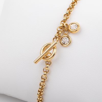 a close up of a gold bracelet with diamonds on it