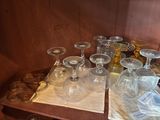 bottles and glasses on a table with a napkin on top of it