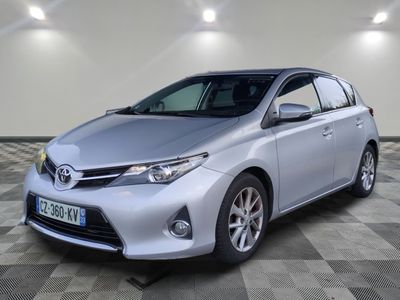 a silver toyota auris parked on a checkered floor