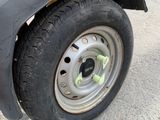 a close up of a truck with a tire on the road