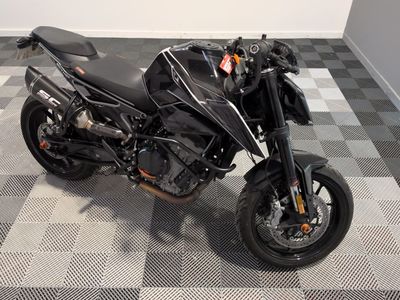 a picture of a black motorcycle parked on a checkered floor