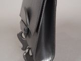 leather purse with a metal handle on a white surface