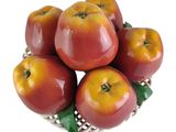 a bowl of apples that are sitting on a table