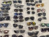 many pairs of sunglasses that are on the table