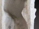 an image of a sculpture of a man ' s torso in a stone block