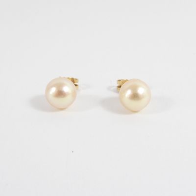 a pair of pearl earrings on a white background
