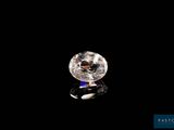 a close up of a white diamond on a black surface