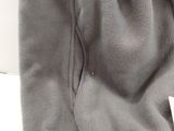 the back of a gray flee jacket with a tag on it