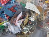 a lot of plastic toys in a bag on a table