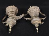 pair of antique silver plated vases on black background