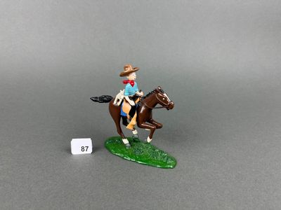 toy figurine of a man riding a horse with a hat on