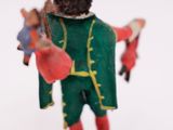 a figurine of a man in a green coat and hat