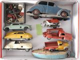 toy cars in a box on a white surface