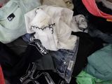 a pile of clothes that is sitting on the floor