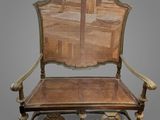 an old chair with a cane back and a cane seat on it