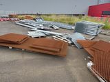 many pieces of metal on the ground in front of a building