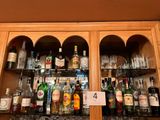 many bottles of alcohol on the shelves in the bar
