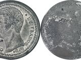 a close up of a coin on a white surface with a white background