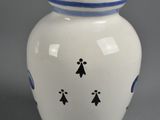 a small white vase with blue trim on it