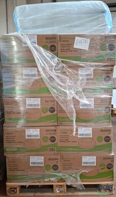 a large stack of boxes on a pallet in a warehouse