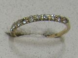 a diamond ring sitting on a table with a white background