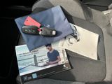 a car seat with a book and a pair of sunglasses on it