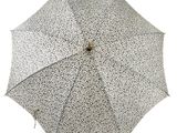 a black and white umbrella that is open on a white background